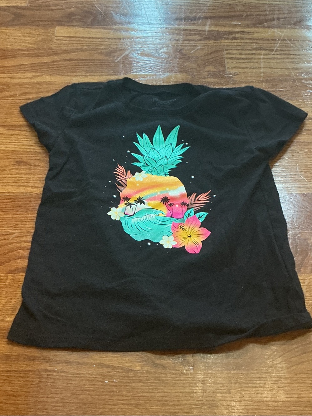 Place Black Tee with Neon Pineapple Sunset Graphic